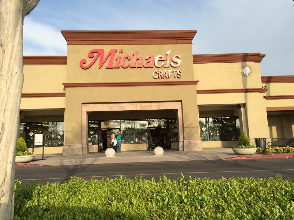 A sign is posted on the exterior of a Michaels art and crafts