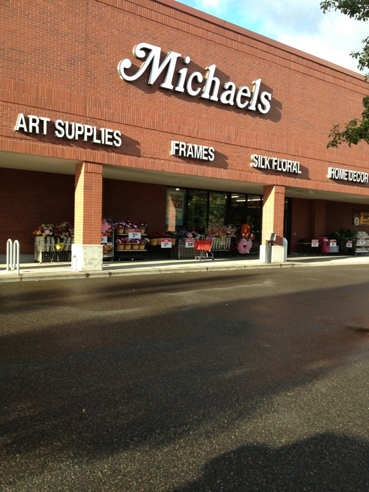 A sign is posted on the exterior of a Michaels art and crafts