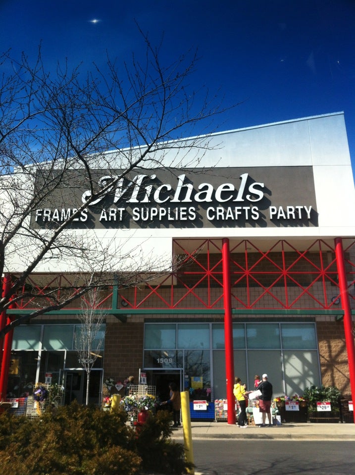 A sign is posted on the exterior of a Michaels art and crafts