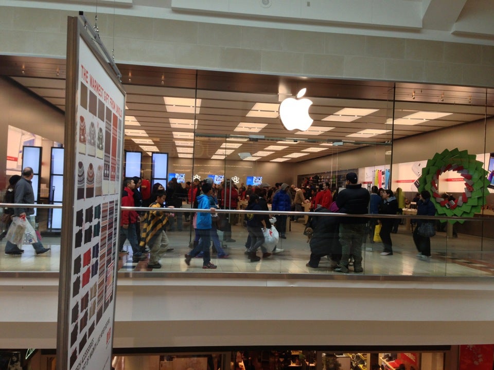 File - People shop at an Apple store in the Westfield Garden State